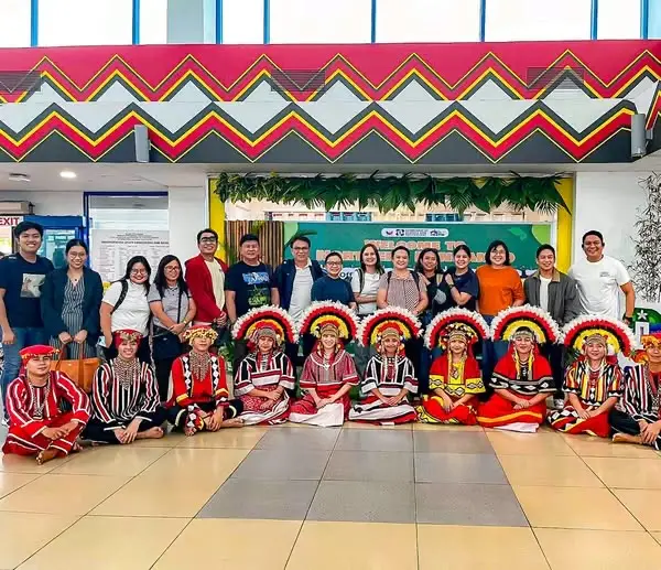 Performers in Dinagyang festival costumes with startup teams