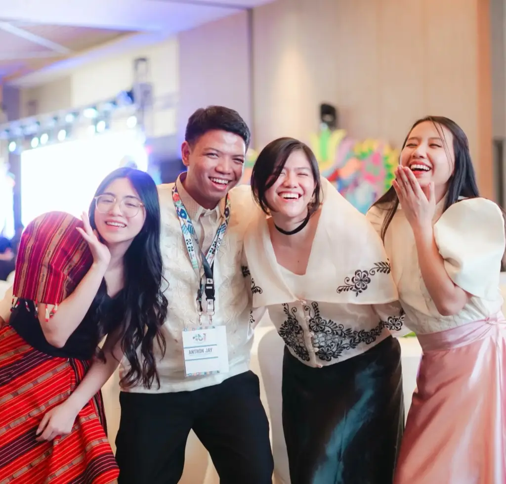 Young founders laughing together at an evening event