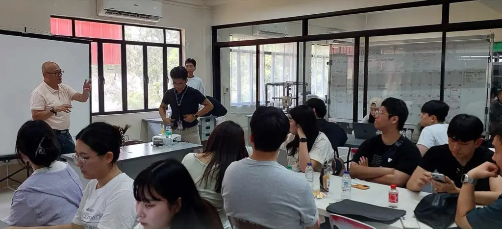 Teams working at shared tables in an incubator space